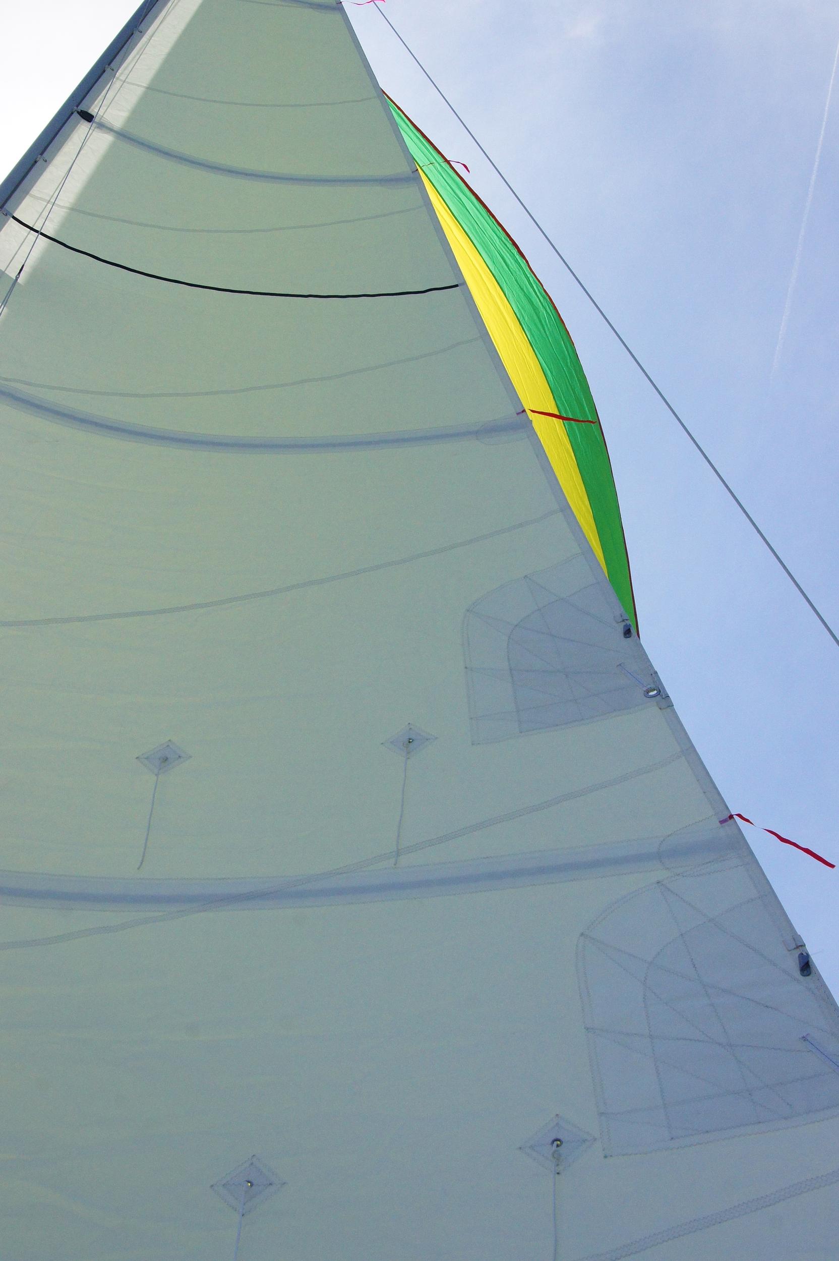 The spinnaker peaking around another sail.
