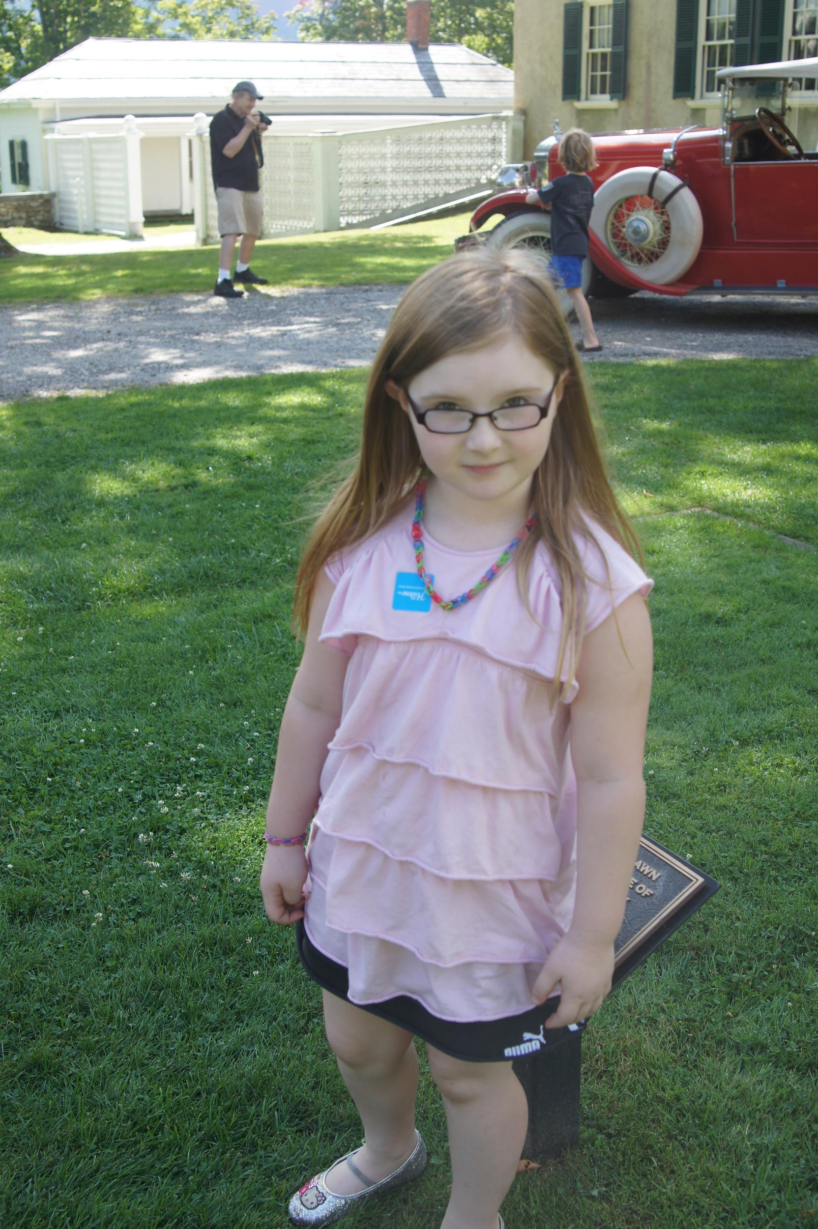 Yessa in the middle of a brick square showing the size of the cabin where Honest Abe was born. 