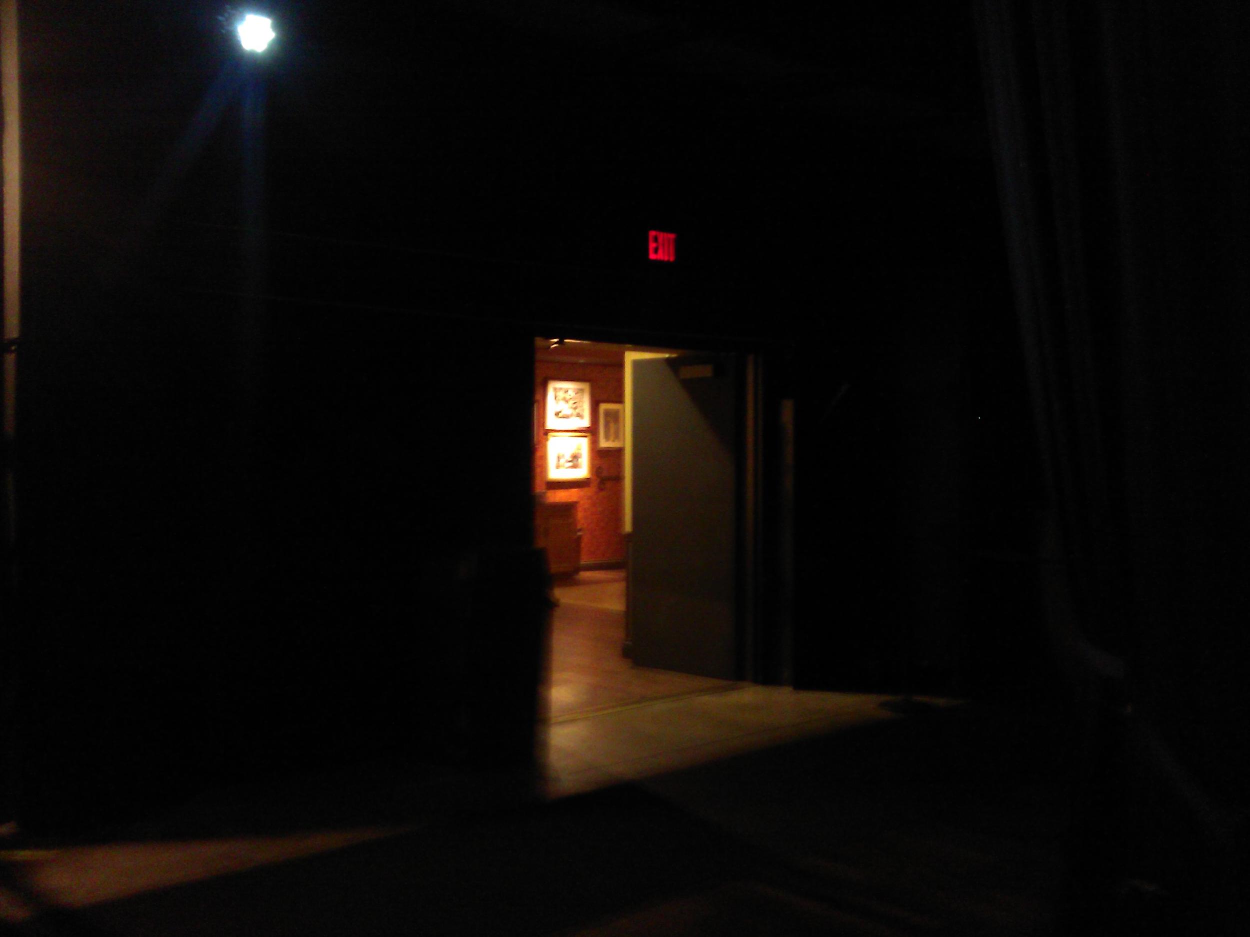 The view back into the dressing room as an artist waits behind the curtain to be announced.
