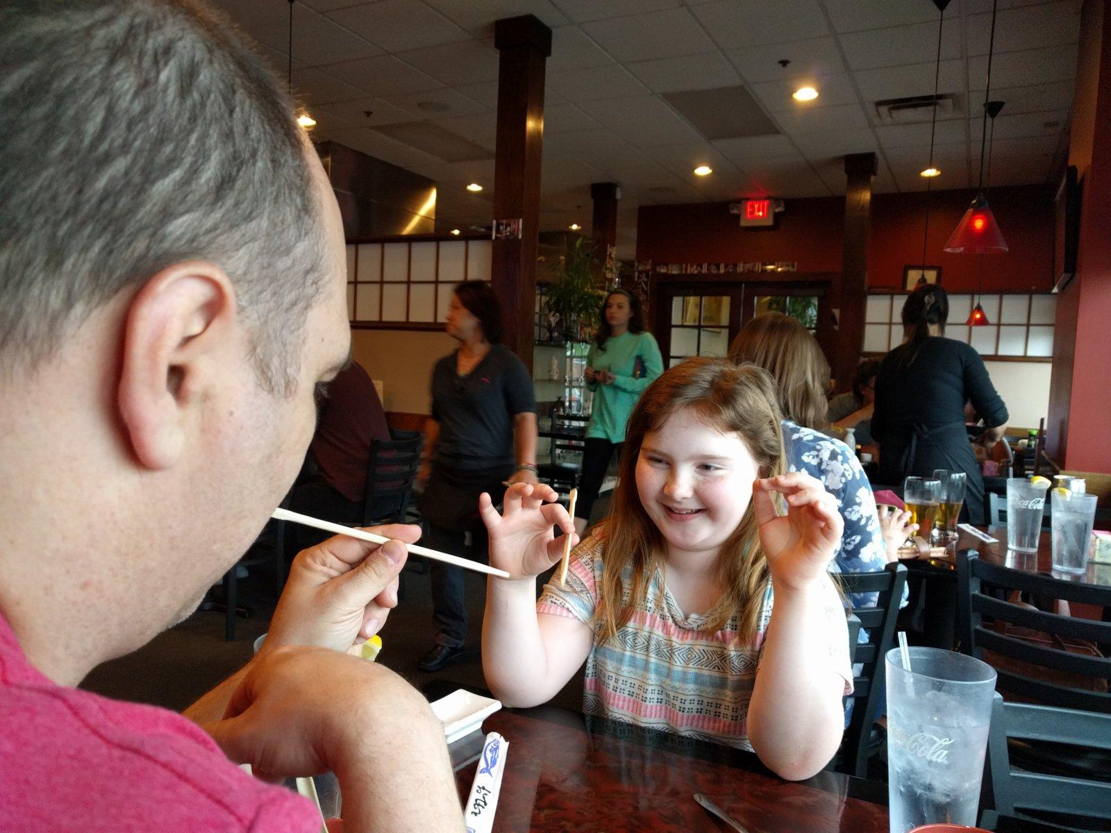 Learning to use the chopsticks.